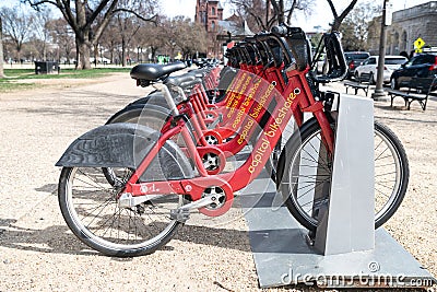 Parking for rental bikes in central Washington. A number of fixed red bicycles for rent in a mobile application Editorial Stock Photo