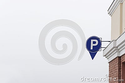 Parking sign against cloudy sky. Symbol of basement parking Stock Photo