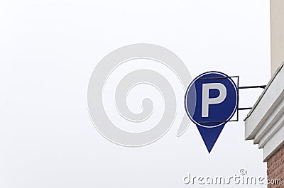 Round parking sign on the building wall.Empty space Stock Photo