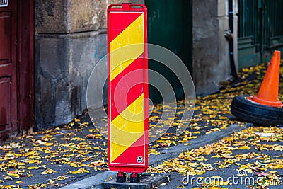 Parking spot with orange safety cones standing and autumn leaves in Bucharest, Romania, 2019 Editorial Stock Photo