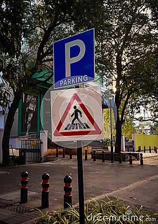 parking and zebra crossing sign board on the roadside Stock Photo