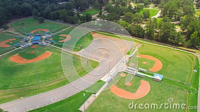 Parkside residential neighborhood near large sport complex with multiple baseball, softball fields surrounding by lush green trees Stock Photo