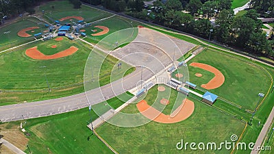 Parkside residential neighborhood near large sport complex with multiple baseball, softball fields surrounding by lush green trees Stock Photo