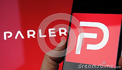 Parler app logo seen on the screen of smartphone and on the blurred background. Parler is a new social media platform promoting Editorial Stock Photo