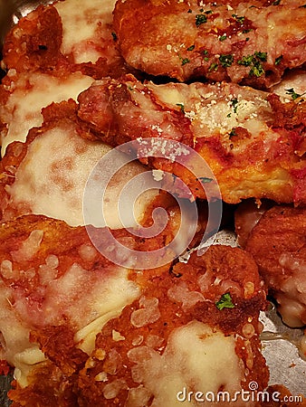 parmesan style fried chicken pieces with melted cheese, traditional Italian food Stock Photo