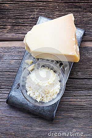 Parmigiano Reggiano Cheese over rustic wood. Stock Photo