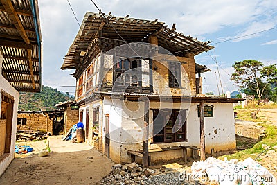 Paro, Bhutan - October 24, 2021: Decrepit looking farm house. Traditional Bhutanese architecture. Wooden roof protected by Editorial Stock Photo