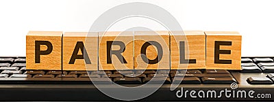 PAROLE word made with building blocks. A row of wooden cubes with a word written in black font is located on a black keyboard Stock Photo