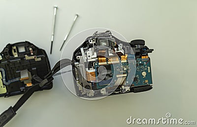 Parsing a digital camera. Digital camera in partially disassembled form, visible chips and loops Stock Photo
