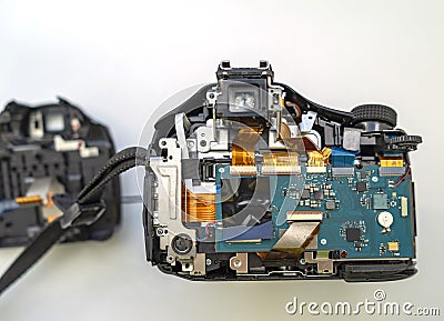 Parsing a digital camera. Digital camera in partially disassembled form, visible chips and loops Stock Photo