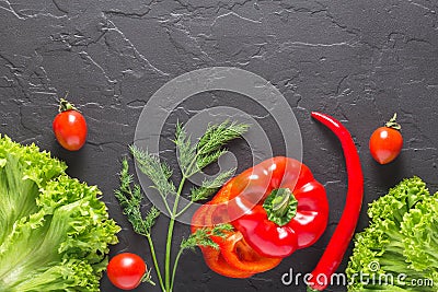 Parsley, dill, cabbage leaves, pepper on a dark concrete background. Fresh products for salads and vegetarian food. Stock Photo