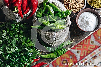 Parsley, red and green hot peppers in linen bags and spices Stock Photo