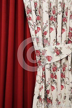 Part of beautifully draped curtain on the window in the room. Close up of piled curtain. Luxury curtain, home decor. Floral roses, Stock Photo