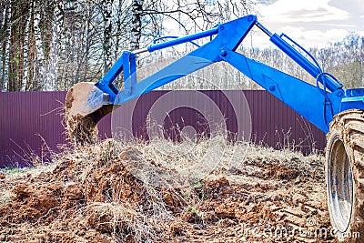 Part of the blue excavator works on the site. Stock Photo