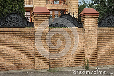 Part of a brown wall of a brick fence Stock Photo