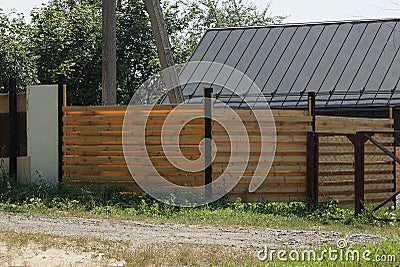 Part of a brown wall of a fence made of wooden planks Stock Photo