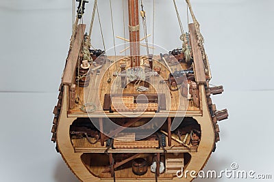 Part of cut wooden toy ship model with small details inside. Boat miniature on white background. Woodwork and hobby concept Stock Photo