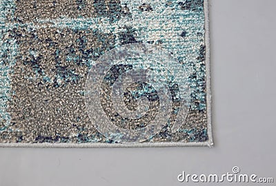 Part of a dirty carpet on a grey floor Stock Photo