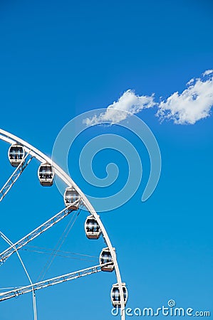Part of ferris wheel against a blue sky background. Ferris wheel with cabins in a minimalist style. Straight view of ferris wheel Stock Photo