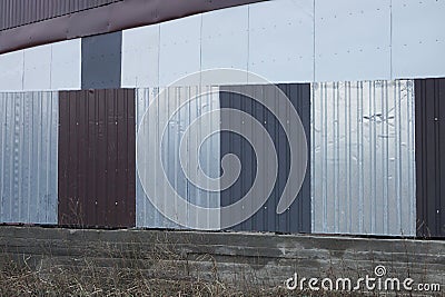 Part gray white metal fence wall Stock Photo