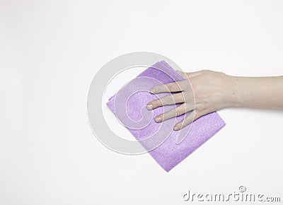 Part of the hand with a purple cloth for dusting and removing dirt. Cleaning, white background, free space for tex. Stock Photo