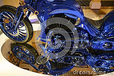 Part of Harley Davidson Blue Edition with front wheel, zylinder blocks, tank, seat blue and gold standing on mirror Editorial Stock Photo