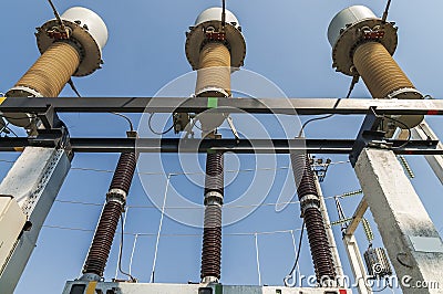 Part of high-voltage substation on blue sky background with switches and disconnectors. Ukrainian energy infrastructure Stock Photo