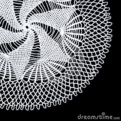 A part of isolated crocheted white doily with a pattern of spiral and fans on a black background. Round decorative doily Stock Photo