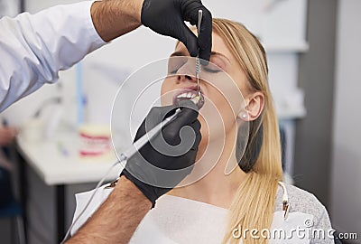 Stomatologist giving woman anesthesia in dentist`s clinic Stock Photo