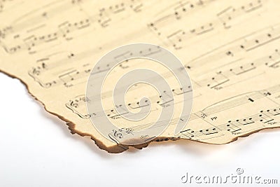 Part of old burnt music sheet on vintage paper and white background Stock Photo