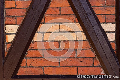 Part of an old wall made of brown half-timbered, bricked with bricks in different shades Stock Photo