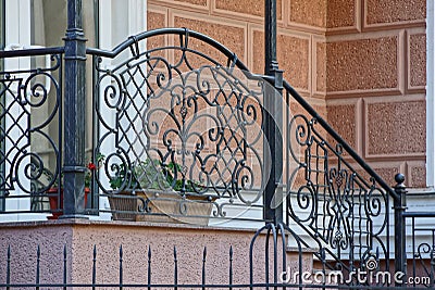 Part of the porch and the threshold with steps with an iron fence of twigs and wrought pattern Stock Photo