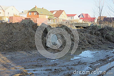 part of a rural road in brown mud and puddles Stock Photo