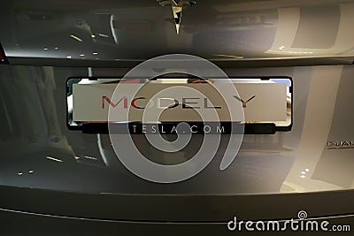 Part of Tesla car model Y in liquid silver dubbed Mercury Silver Metallic color, popular passenger electric vehicle in showroom, Editorial Stock Photo