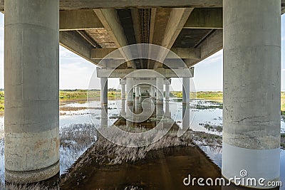 part under the Vasco da Gama bridge in perspective of infinity with the supporting pillars visible. Stock Photo
