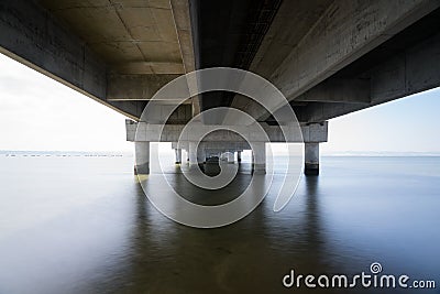 part under the Vasco da Gama bridge in perspective of infinity with the supporting pillars visible. Stock Photo