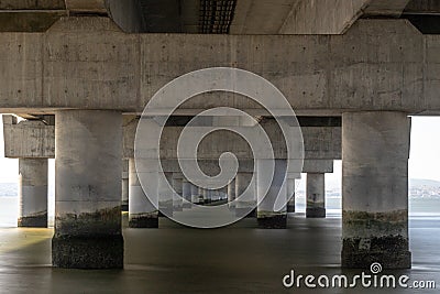 part under the Vasco da Gama bridge in perspective of infinity with the supporting pillars visible. Stock Photo