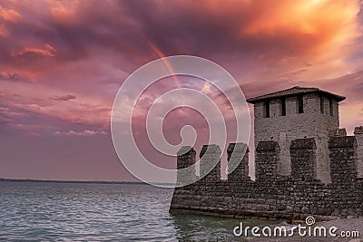 part of the walls of the Scaliger castle of the town of Sirmione at sunse Stock Photo