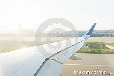 Traveling by plane. View from the window to the clouds and dawn. Stock Photo