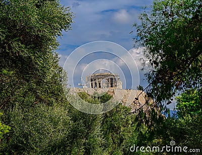 Parthenon on acropolis hill between green folliage, Athens Greece Stock Photo