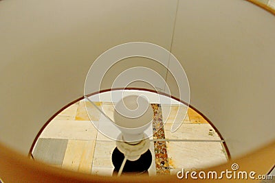 Abstract. Lamp inside a beige abjur top down view Stock Photo