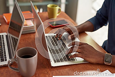 Partial image of black man typing on laptop Stock Photo