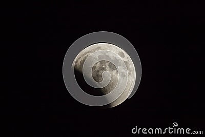 Partial lunar eclipse in summer night over the Judean desert near the town of Mitzpe Ramon in Israel Stock Photo