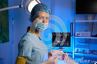 Female doctor using syringe for embryo transfer in reproductive clinic Stock Photo