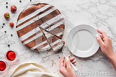 partial top view of person putting piece of delicious homemade cake Stock Photo