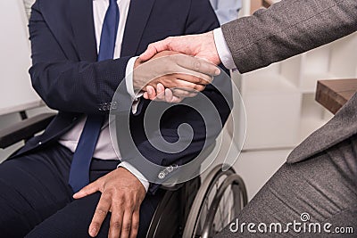 partial view of businessmen in suits shaking hands Stock Photo