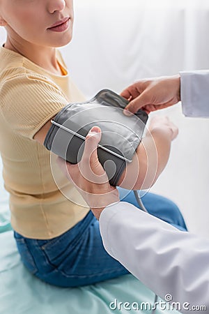 partial view of doctor putting cuff Stock Photo