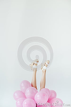 partial view of female legs and bunch of balloons Stock Photo