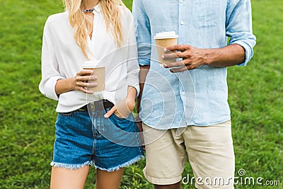 partial view of man and woman holding coffee to go Stock Photo