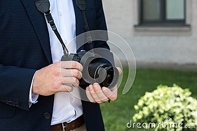 partial view of photojournalist in suit with digital Stock Photo